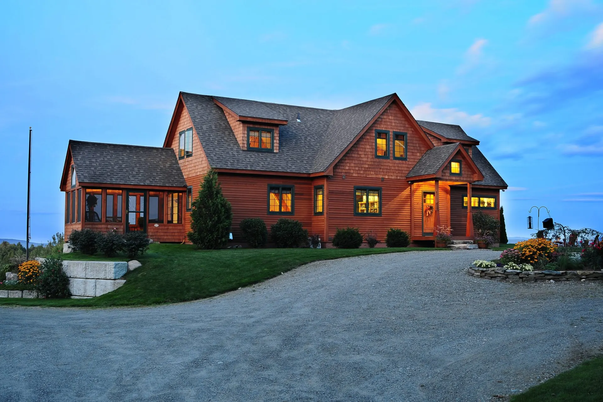 Custom timber home built by Crown Point Contracting, lit at dusk