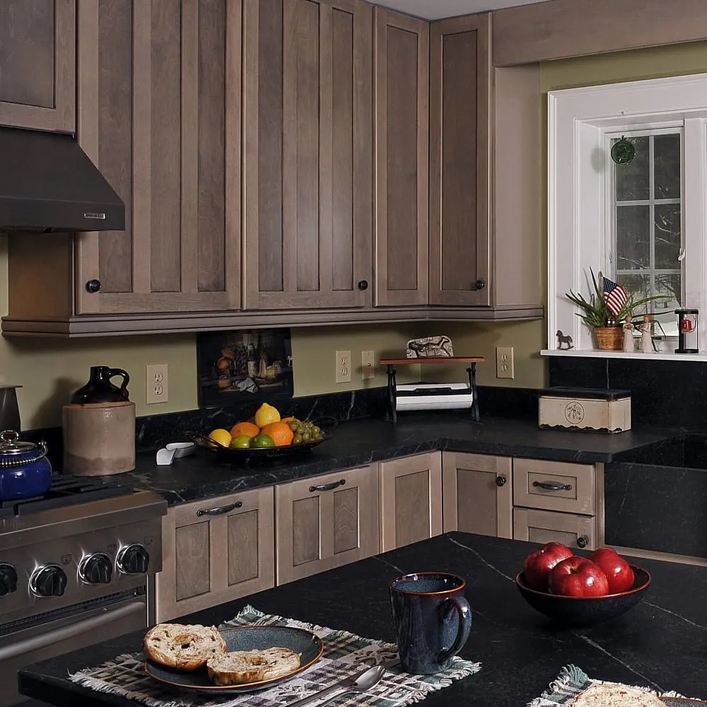 Renovated kitchen with dark stone countertops